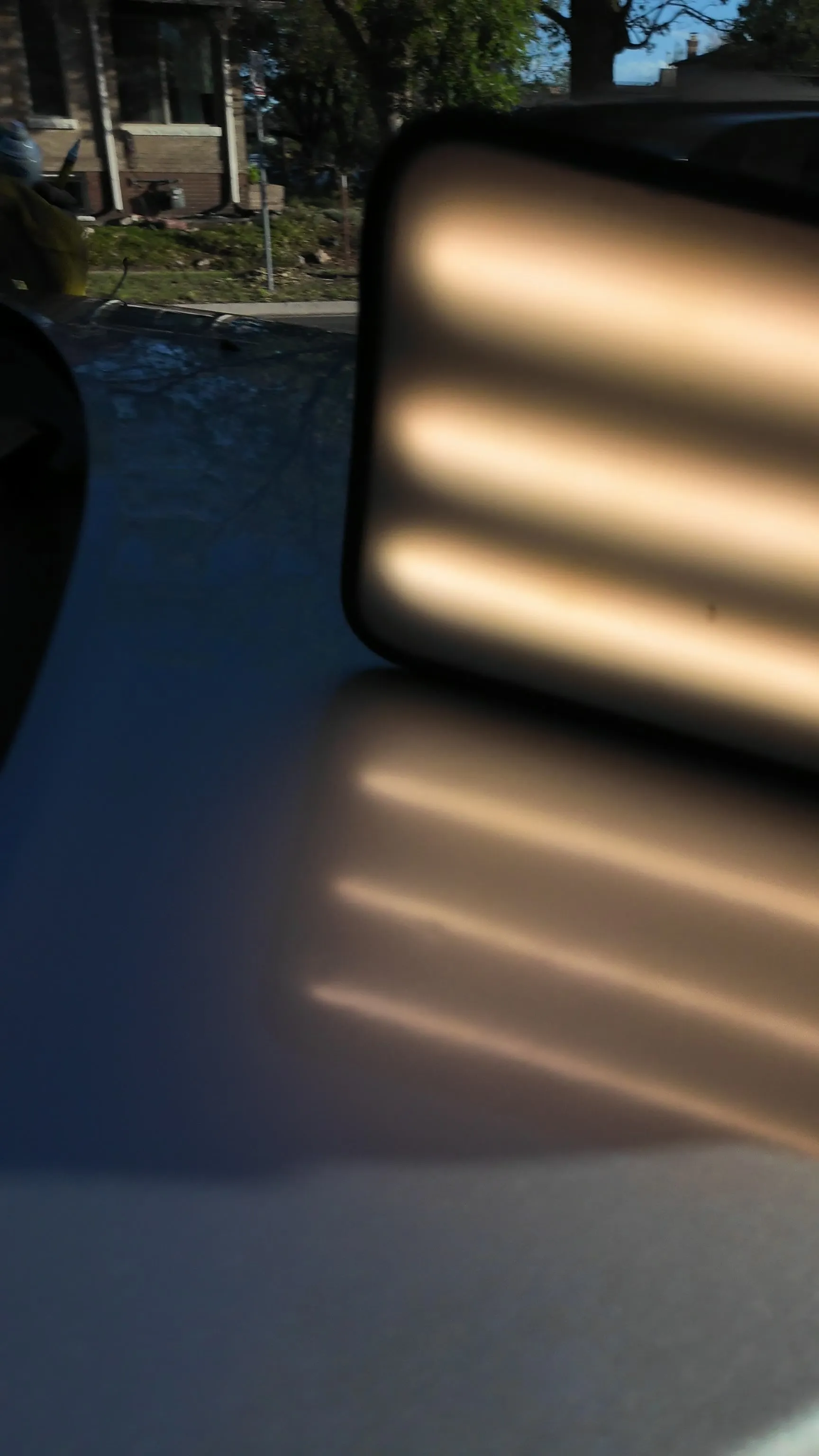 Sunlight reflection board revealing hail dents on a hood — real repair, Aurora CO